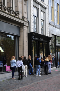 900256 Afbeelding van winkelend publiek dat in de rij staat voor de ingang van kledingwinkel Subdued (Oudegracht 165) ...